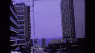 Spain (1972): Downtown Buildings With An Ocean View Then Switching To Grass Huts