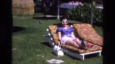 Spain (1972): Two Women On Lounge Chairs Wearing Summer Clothes On A Sunny Day