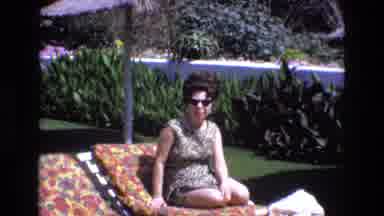 Spain (1972): Woman Sitting On Lounge Chair Wearing Swimsuit