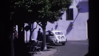 Spain (1972): People Waiting On A Street Corner And A Taxi Cab Driving By