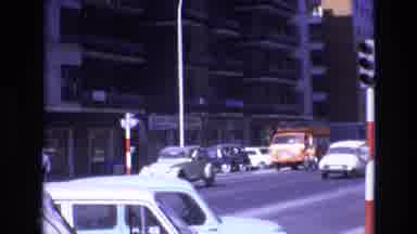 Spain (1972): Urban View Of Buildings Street Traffic And People On Sidewalk