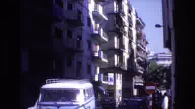 Spain (1972): Several Cars Driving On A City Street During The Day