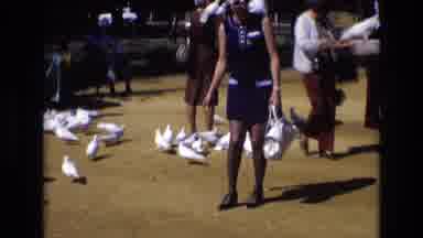 Spain (1972): Woman With Birds And Front Of Large Building