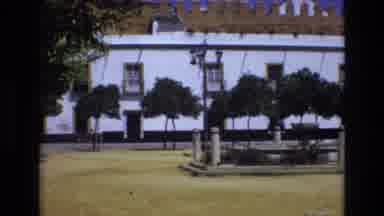 Spain (1972): Male Walking On Sidewalk Near None Running Fountain
