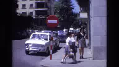 Spain (1972): Two Girls Crossing Street Stepping Onto Sidewalk And Two Boys
