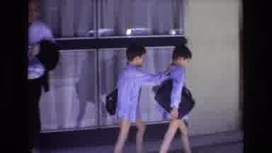 Spain-1972: Two Matching Boys Walking With Briefcases On Sidewalk