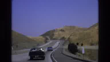 Central Coast California USA (1973): Cars Driving On A Curved Road Near Hills