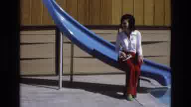 Central Coast California USA (1973): 1960s Couple Hugging On A Playground Slide