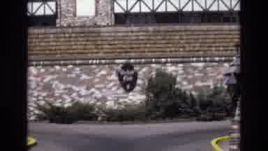 Colorado USA (1973): Man Standing In Street By Buildings Holding Bag