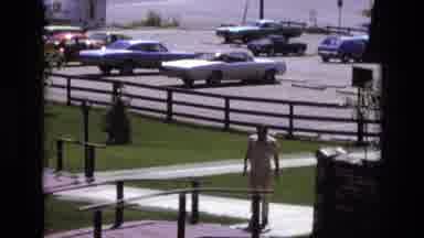 Colorado USA (1973): Man In White Walks Across A Small Bridge While Waving To The