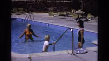 Colorado USA (1973): Two Women Are Teaching And Guiding Kid How To Swim In A