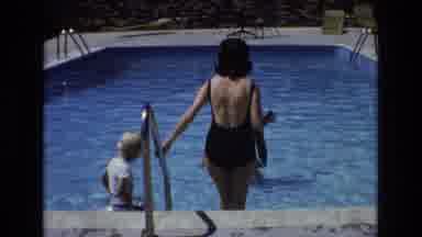 Colorado USA (1973): Women Sporting Black And Orange Swimwear Taking Afternoon Dip