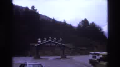 Colorado USA (1973): A Parking Lot With A Decorative Sign Sits Below A