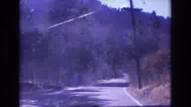 Colorado USA (1973): Someone Typing While Someone Is Driving Down A Road Street