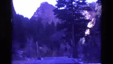 Colorado USA (1973): A Highway Runs Through A Forest At The Base Of A Mountain