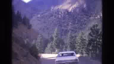 COLORADO SPRINGS COLORADO USA .-1973: White Car Driving On A Mountainous Road