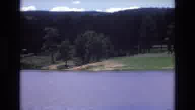 Lake Tahoe Nevada USA (1973): A Sparkling Pond With Grass Trees And A Small Cabin