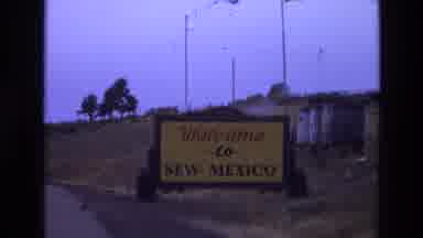 New Mexico USA (1973): A Woman Awkwardly Standing In A Driveway And A Sign