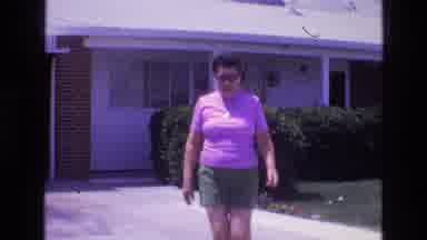 New Mexico USA (1973): Woman Wearing Sunglasses In A Pink Shirt And Brown Shorts
