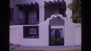 New Mexico USA (1973): A Car Turns Down A Street With Near An Adobe Style House
