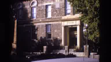 New Mexico USA (1973): Cars Driving Past A Building Entrance
