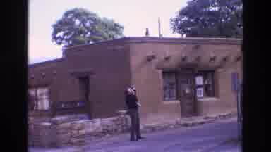 New Mexico USA (1973): Man In Front Of Brown Adobe Building