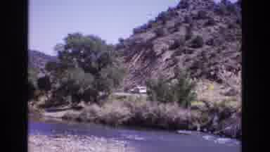 New Mexico USA (1973): Cars Passing On A Mountain Road Near A River