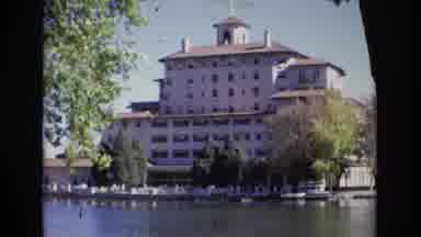 Colorado Springs Colorado USA (1974): Large Hotel Behind Treed River Waterway