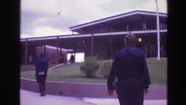 South Dakota USA (1974): People Walking Toward And Away From Large Building In The