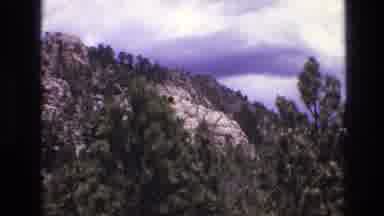 South Dakota USA (1974): Mountain Covered With Trees On A Mostly Cloudy Day