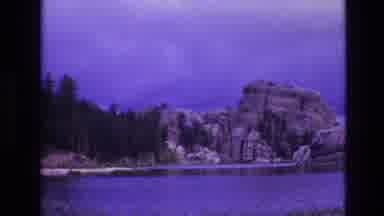 South Dakota USA (1974): A Line Of Boulders Near A Forest By The Lake