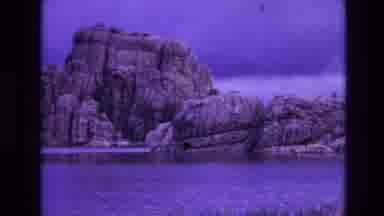 South Dakota USA (1974): A Rock Formation Has A Lake At Its Base Fringed With