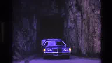 South Dakota USA (1974): Station Wagon Exiting Tunnel While Pulling Camper