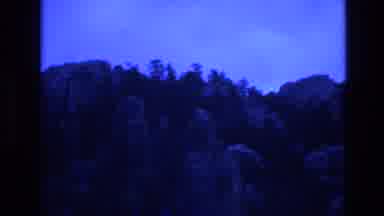 South Dakota USA (1974): The Camera Pans Along A Rocky Mountain Top With Trees And