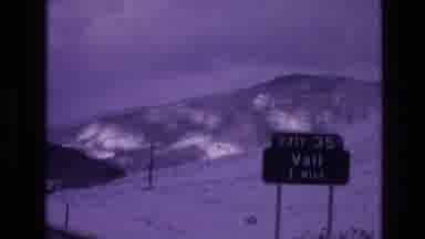 Vail Colorado USA (1974): Car Driving Past A Snowy Mountain Town
