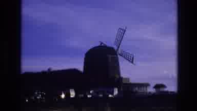 Vail Colorado USA (1974): Driving Past A Large Windmill Turning Passing A Parking