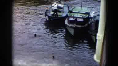 Cuba (1956): A Bay With Several Large Cargo Boats Docked And Then A Man Walking
