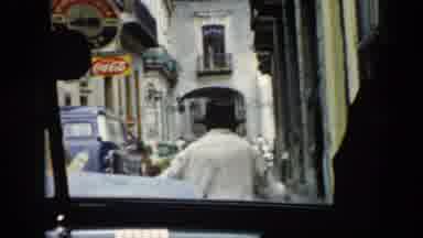 Cuba (1956): Passenger Films A Man With A Black Hat Passing In Front Of The Car