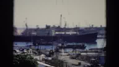 Cuba (1956): A Large Ship Moving Through A Port Area