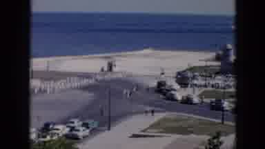 Cuba (1956): People Marching Across A Road Near The Ocean