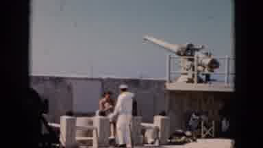 Cuba (1956): A Woman Seated Below An Artillery Piece Shakes Hands With A Sailor