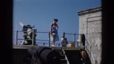 Cuba (1956): Woman In Dress Sitting Down On Steps Next To Cannon
