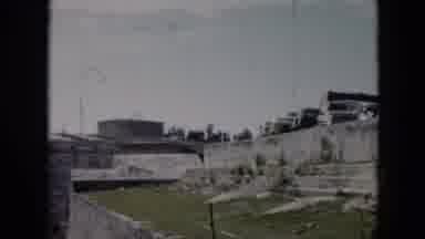 Cuba (1956): Vehicles Parked In A Grassy Field