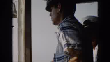 Cuba (1956): Man Wearing A Hat Steering A Boat