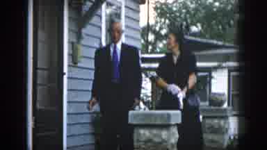 Dayton Ohio USA (1958): Man And Woman Are Dressed Up And Leaving For Church Or