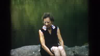 Dayton Ohio USA (1958): Woman Sitting On A Rock By Lake While Two People Walk On