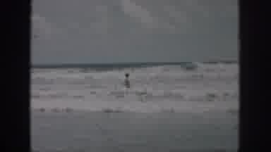 New Orleans Louisiana USA (1958): Woman In Bikini Walking Through Ocean Waves
