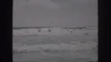 New Orleans Louisiana USA (1958): Men Rollick In The Waves Of Lake Michigan On A