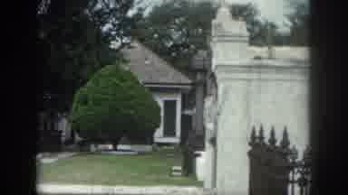 New Orleans Louisiana USA (1958): A Tree Stands In Front Of A Gated Tomb In A