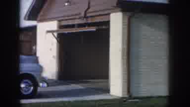 New Orleans Louisiana USA (1958): A Man Rides A Bike Past A Blue Car Sitting